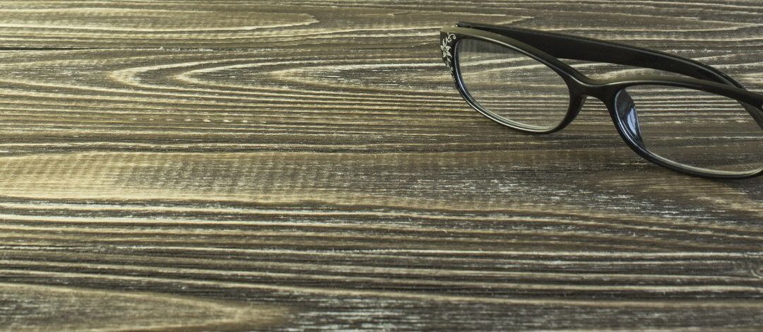Glasses lie on a wooden background